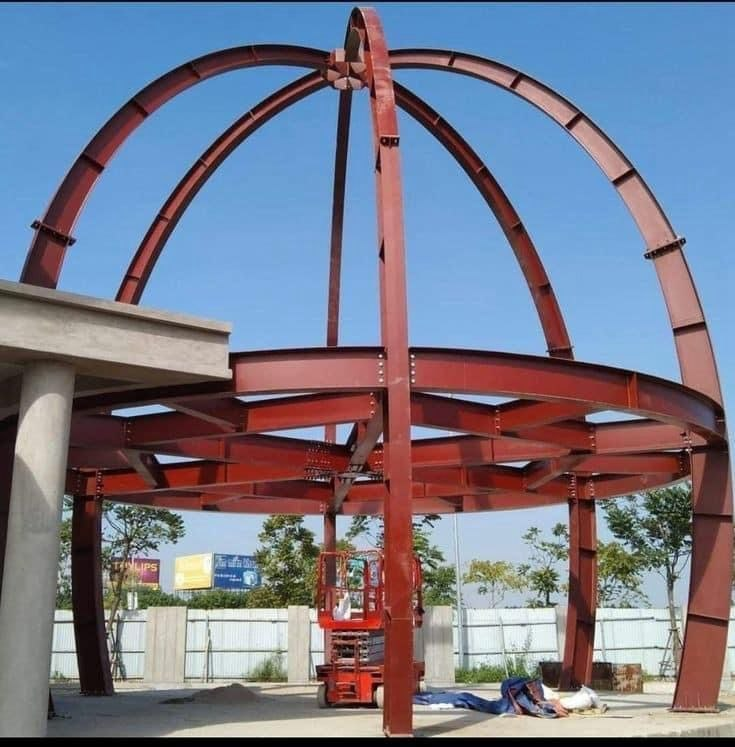 Red spherical steel structure under construction